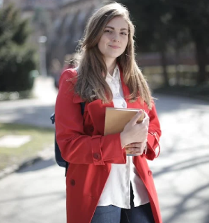 A student holding a translated handbook