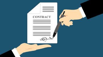A hand signing a contract document.